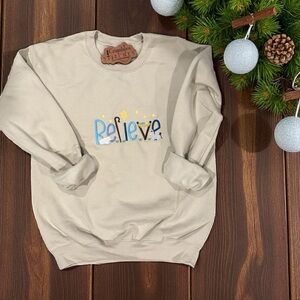 Gildan Sand colored Sweatshirt with 'Believe' manger scene embroidered